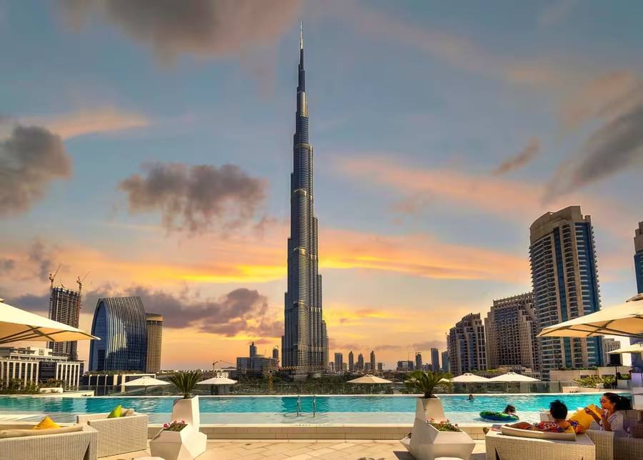 Burj Khalifa at sunset above a rooftop pool